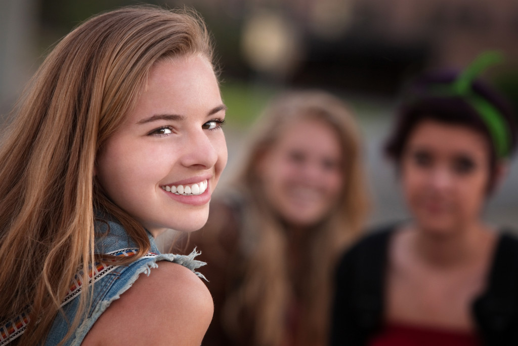 Smiling Teen Girl With Two Friends Austin Orthodonti