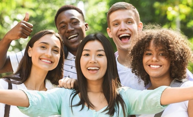 Smiling teens showing confidence and healthy teeth from an Orthodontist in Austin, TX