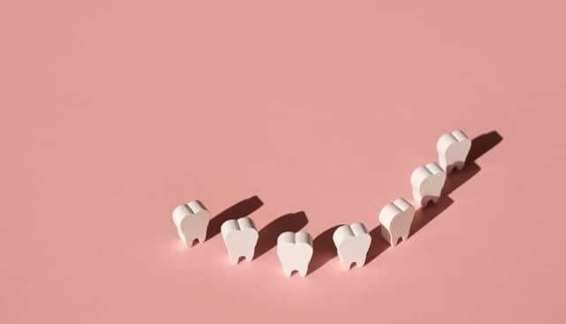 Stylized teeth in curved alignment representing orthodontic care by Orthodontist in Austin, TX